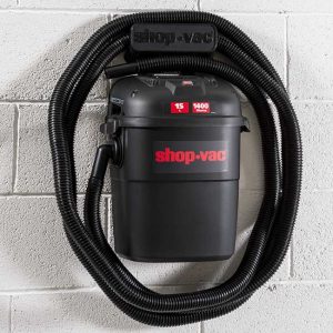 a shop-vac wall mounted vacuum cleaner on a white brick wall