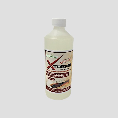 a half-litre bottle of extreme tea coffee and stain remover on a grey background