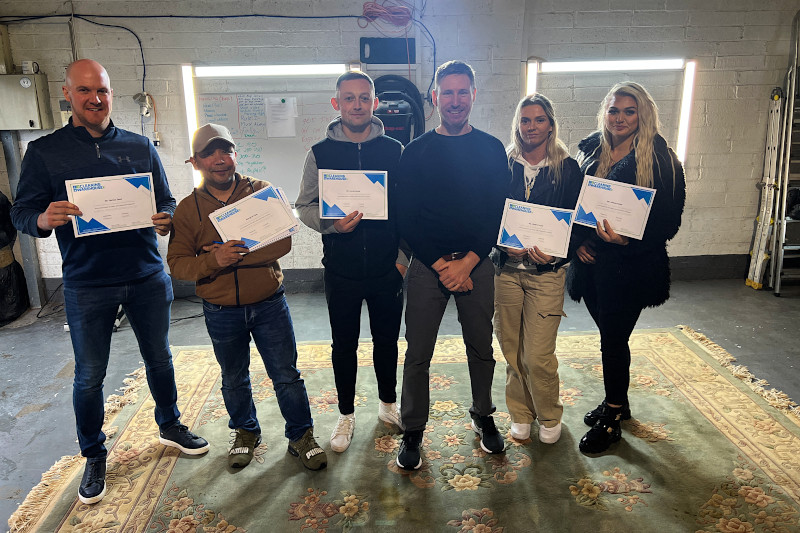 graduated carpet cleaning students holding their certificates up